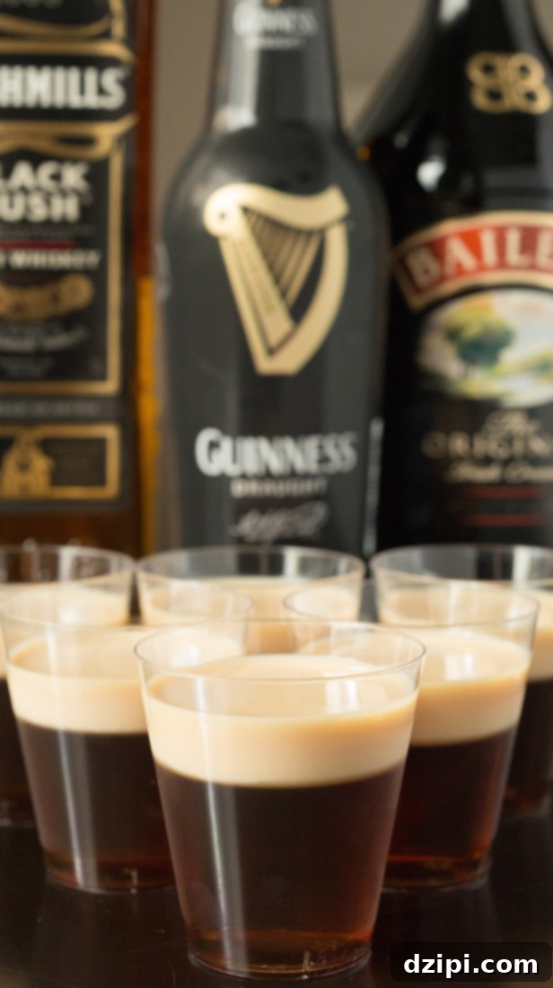 Delicious Irish Slammer Jello Shots featuring a rich Guinness and Irish Whiskey base, topped with a smooth and creamy Bailey's Irish Cream layer.