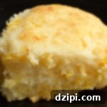 Fluffy Cheesy Buttermilk Biscuits 4 A thick cheesy buttermilk biscuit on a black background