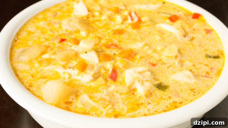 A beautifully presented bowl of homemade corn and crab chowder, rich and creamy, awaiting its special topping.