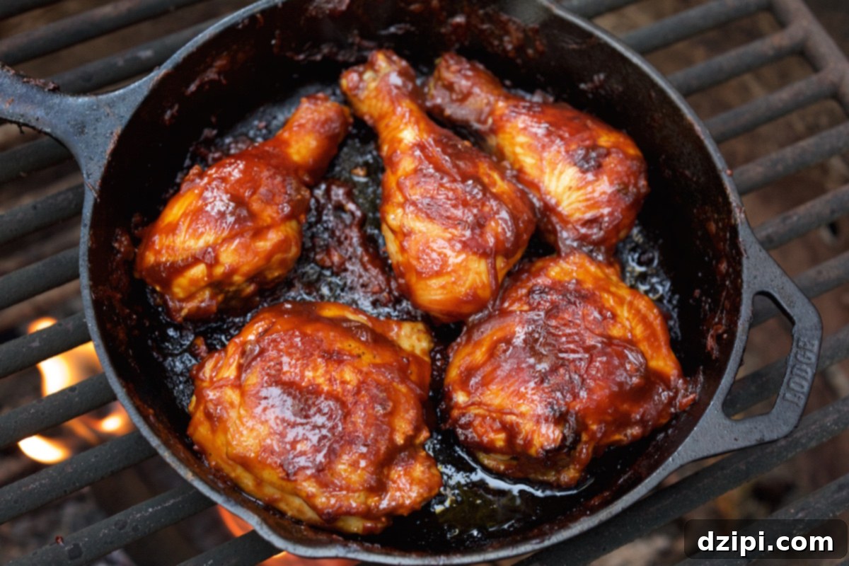 Ingredients for homemade whiskey BBQ sauce laid out on a kitchen counter, showcasing fresh garlic, whiskey, and other components