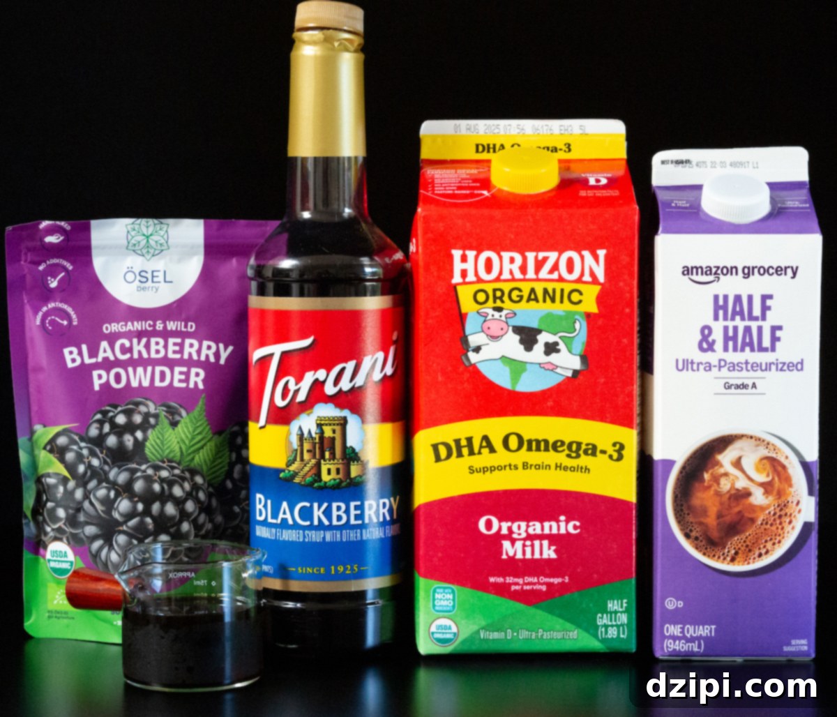 Blackberry powder, blackberry syrup, organic milk, half and half, and a double shot of espresso on a black background.