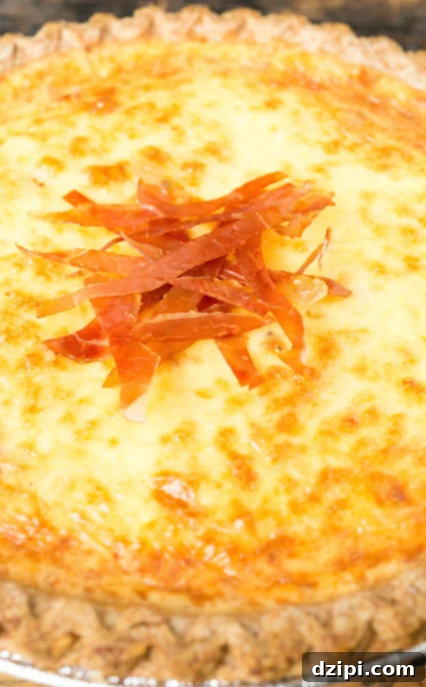 Individual crispy prosciutto slices artfully arranged on top of a freshly baked duck egg quiche.