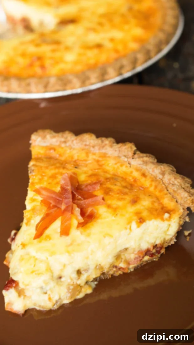 A perfectly baked slice of Bacon Lover's Duck Egg Quiche, showcasing its rich texture and generous bacon filling.