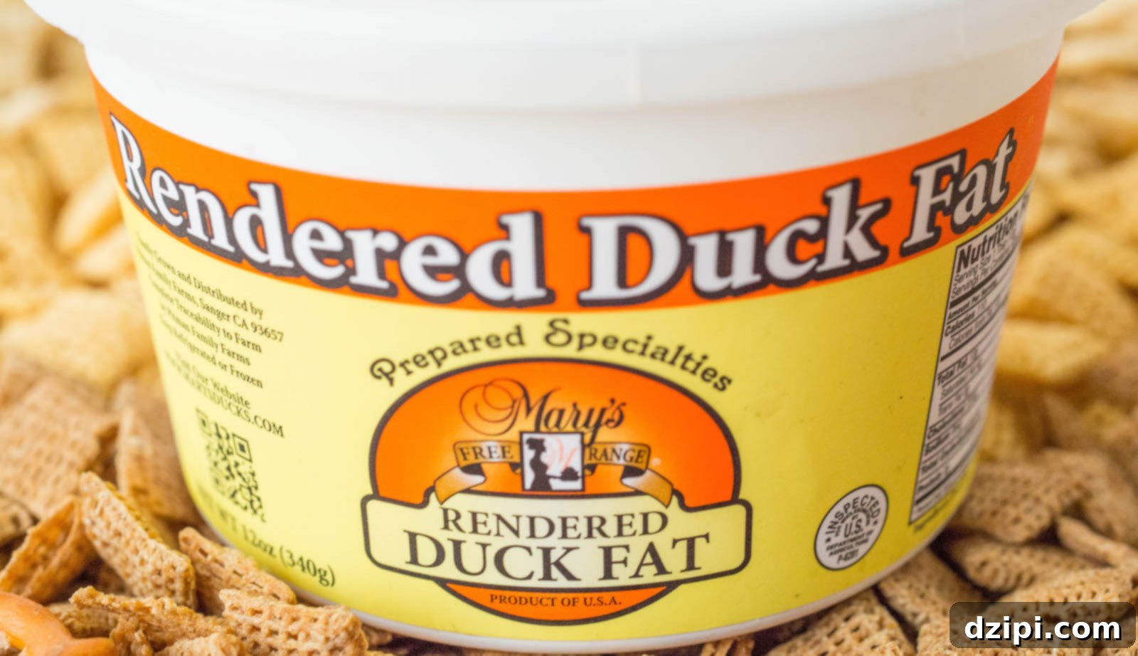 Irresistible Slow Cooker Duck Fat Snack Mix 3 A tub of duck fat Chex mix sitting on top of Chex squares.