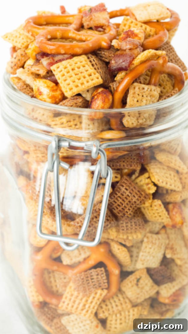 Irresistible Slow Cooker Duck Fat Snack Mix 4 A glass jar with a hinged lid is overflowing with duck fat Chex mix.