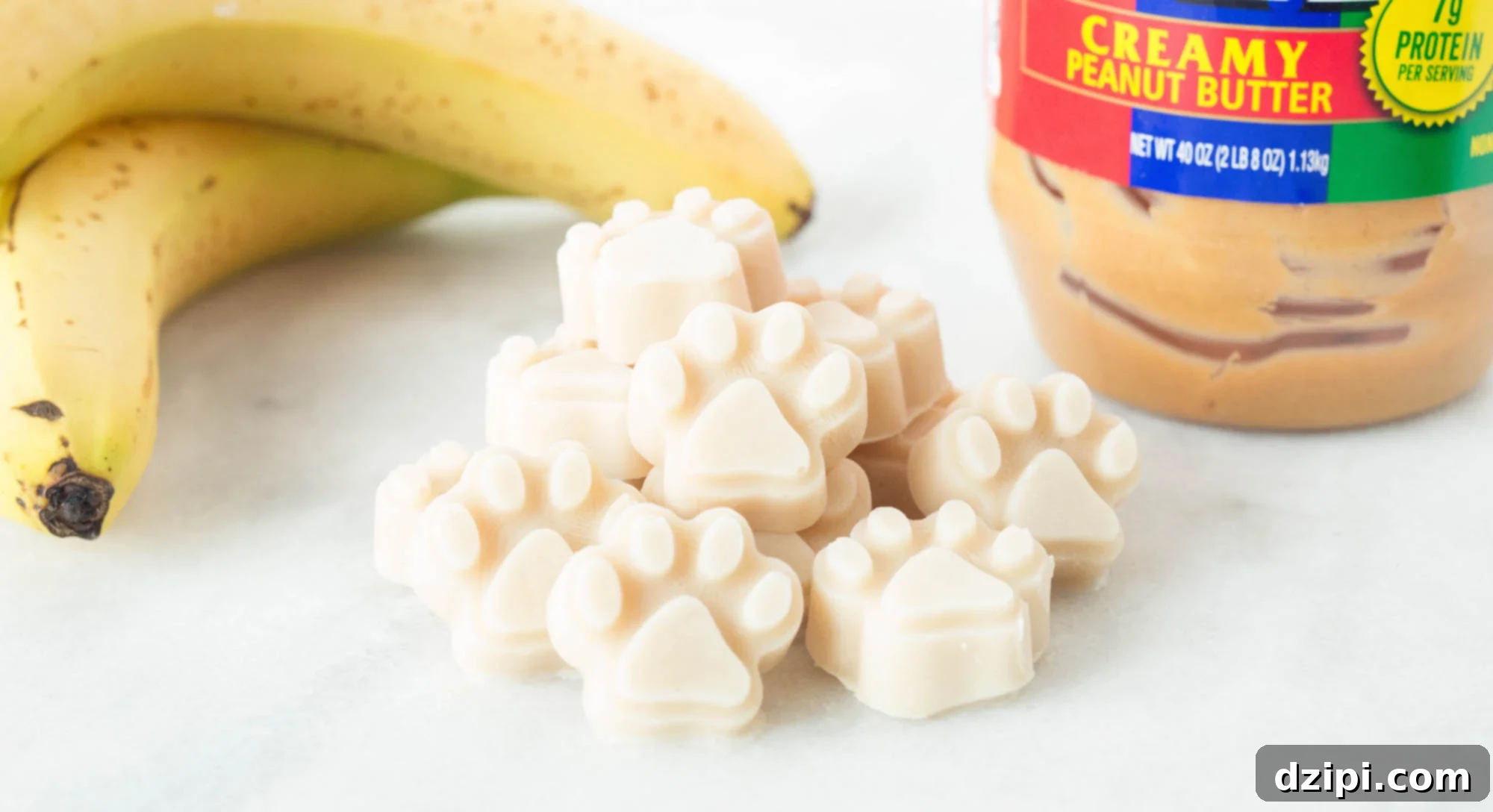 Paw shaped frozen yogurt banana peanut butter dog treats. A delightful, healthy, and cooling treat for your beloved canine companion.