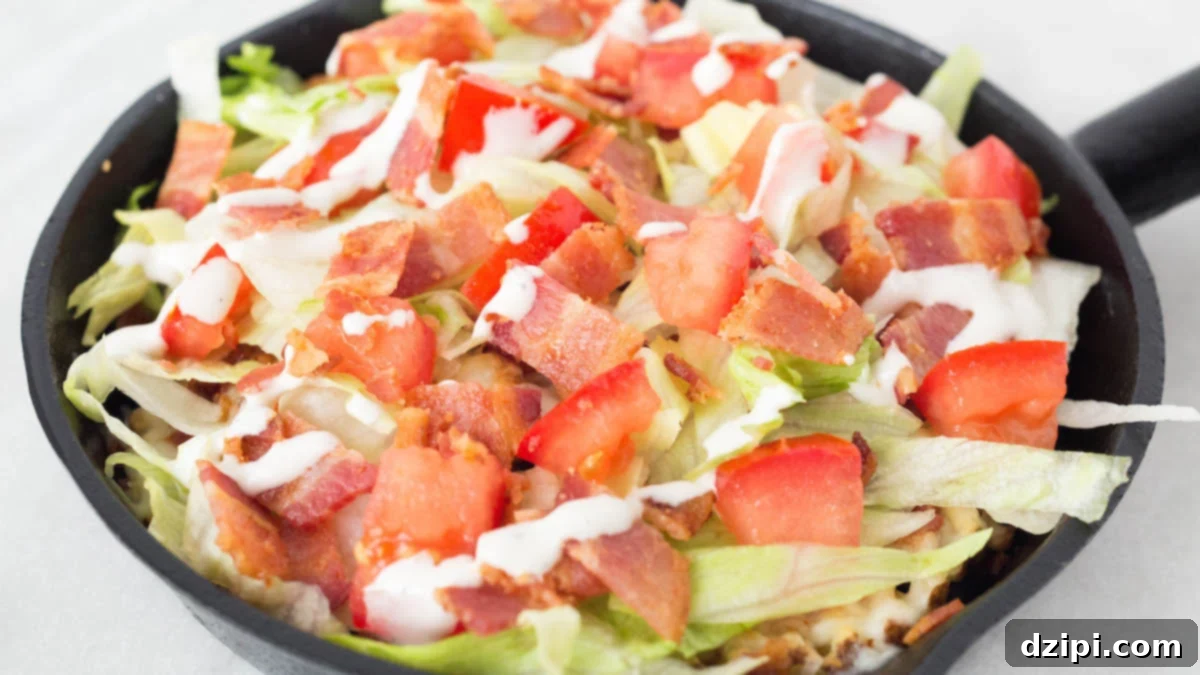 Loaded BLT Waffle Fries 6 A cast iron skillet has been filled with waffle fries on the bottom, then topped with melted mozzarella cheese, slice lettuce, chopped tomatoes, chopped bacon and ranch dressing to make BLT waffle fries.