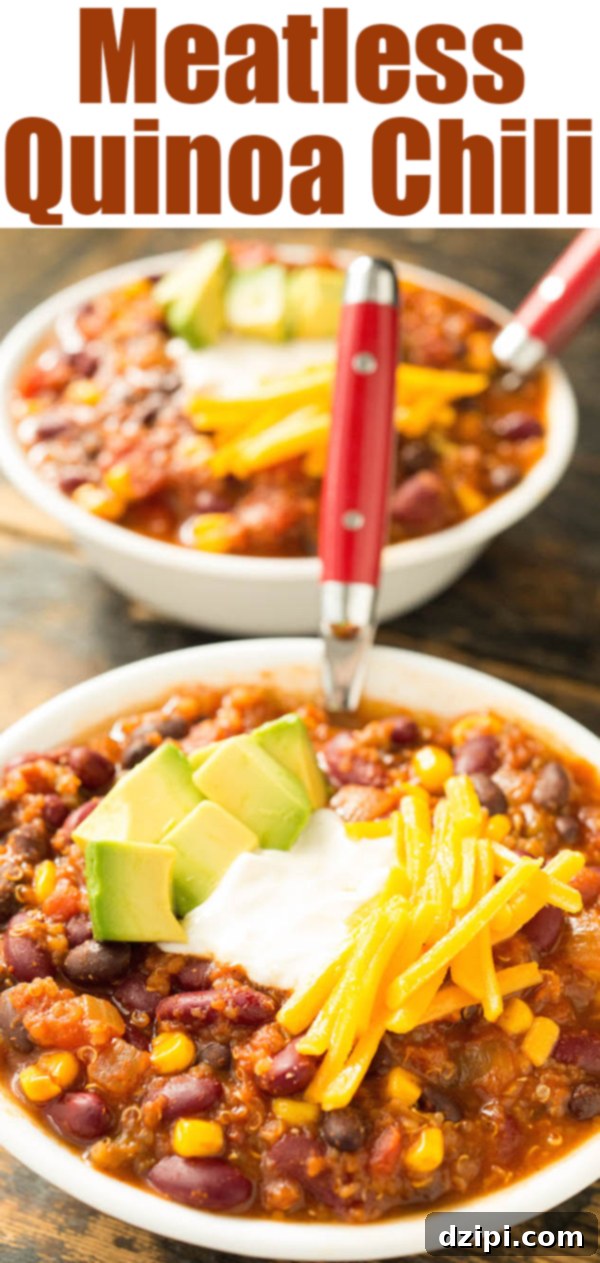 Two bowls of meatless quinoa chili sit on a wood background. The bowls of chili have been garnished with shredded cheddar cheese, a dollop of sour cream, and some chopped avocado. Text at the top reads 'meatless quinoa chili'.