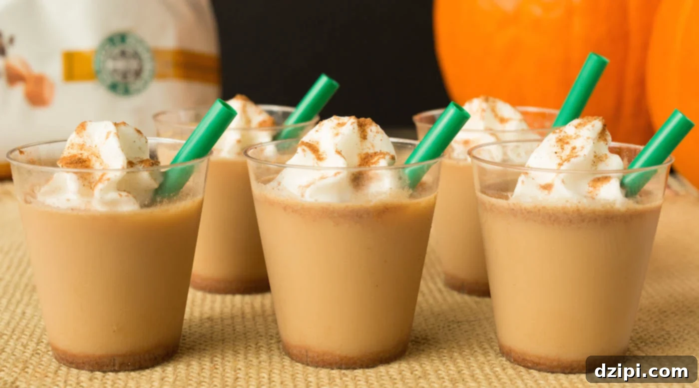 Pumpkin Spice Latte Jello Shot Bliss 2 Five Pumpkin Spice Latte Jello Shots in mini plastic cups with green straws, against a blurry background of a Starbucks bag and an orange pumpkin.