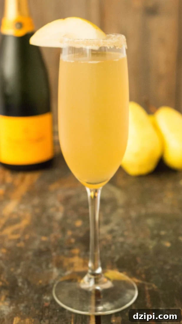 A champagne flute filled with a vanilla bean pear mimosa.