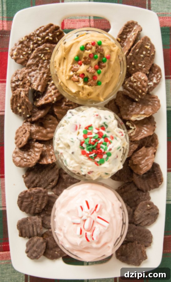 An overhead view of a vibrant Christmas Dessert Dip Platter, showcasing festive Christmas Cookie Dough Dip, spicy Gingerbread Dip, and airy Peppermint Fluff Dip, surrounded by a generous array of Chocolate Wavy Lay's Chips, including Milk Chocolate, Dark Chocolate, and Milk Chocolate with Almond Bits, ready for dipping.
