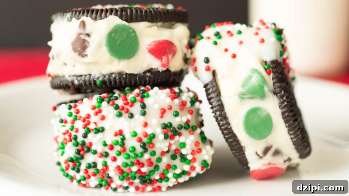 Delicious Christmas cookie dough stuffed Oreos dipped in white chocolate and covered with festive sprinkles, perfect for holiday gatherings.
