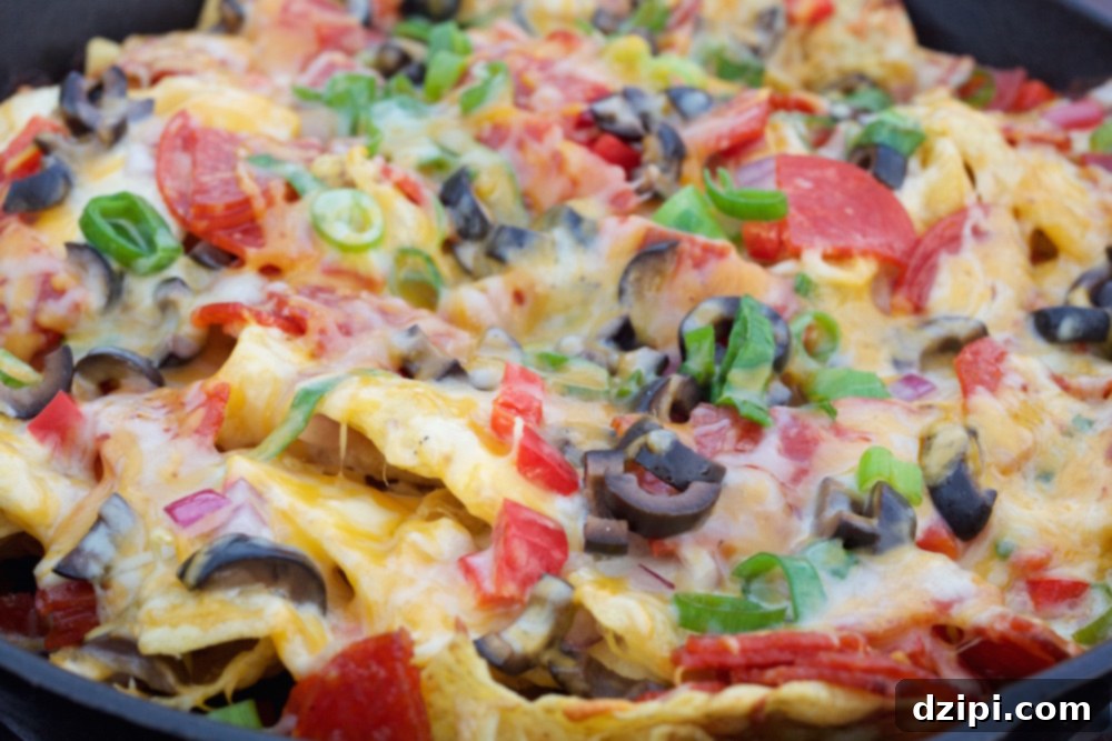 Close-up of perfectly melted and bubbly Campfire Pizza Nachos after cooking, ready to eat.