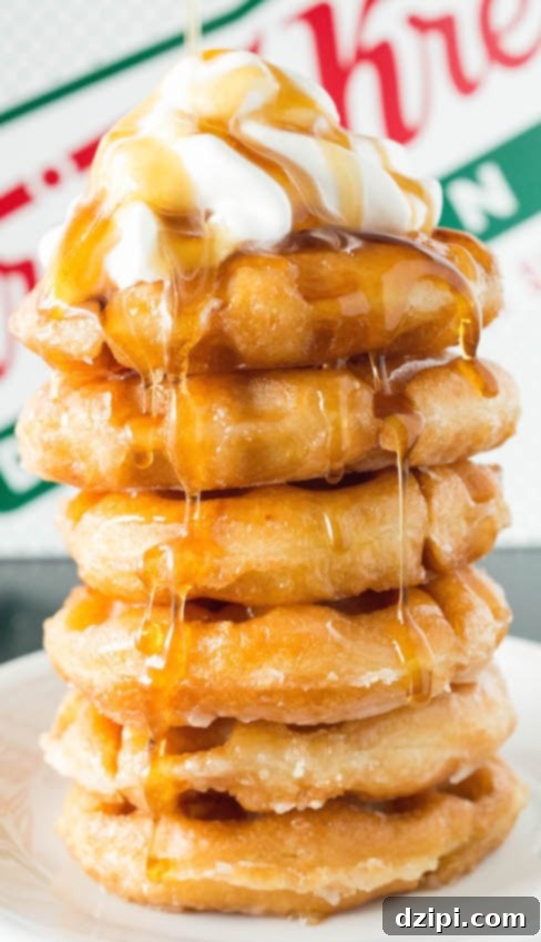 Krispy Kreme Donut Waffles Reimagined 4 A close-up view of a perfectly stacked tower of Krispy Kreme Donut Waffles, glistening with syrup and adorned with a dollop of whipped cream, inviting you to take a bite.
