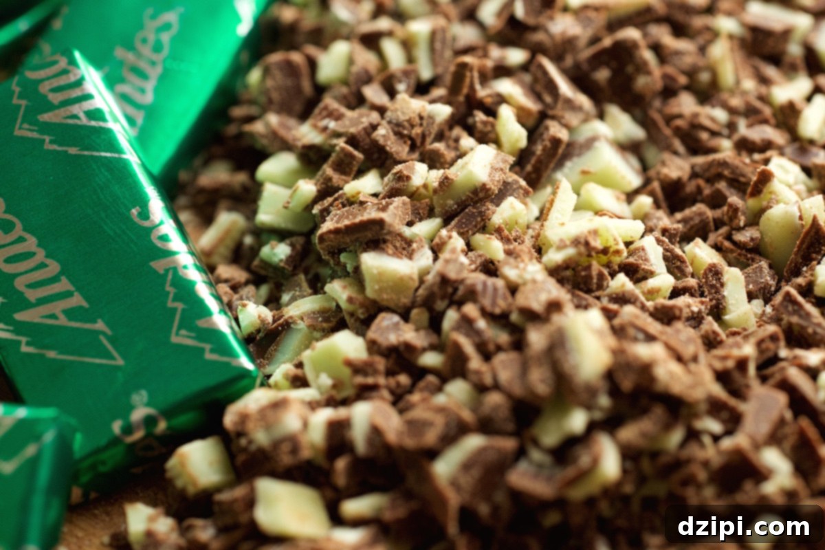 Cool Mint Chocolate Cheesecake Popsicles 3 An extreme close-up shot of finely chopped green and brown Andes mints, scattered and ready to be used as a delicious coating for mint chocolate cheesecake popsicles.