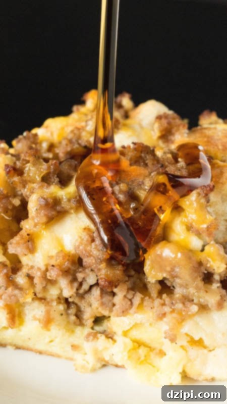 Maple syrup being poured over a slice of Egg McMuffin casserole.