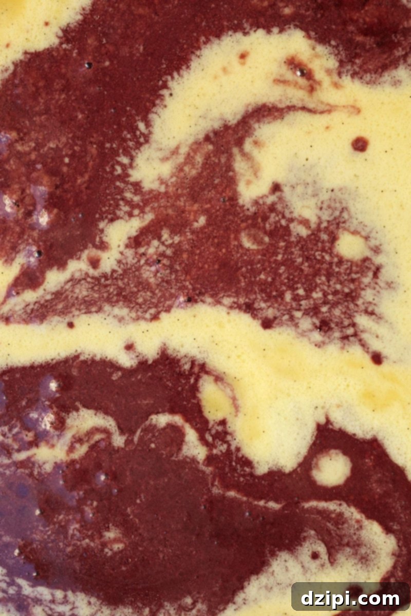 Swirled ingredients for red wine ice cream, showcasing the rich color and creamy texture before freezing.