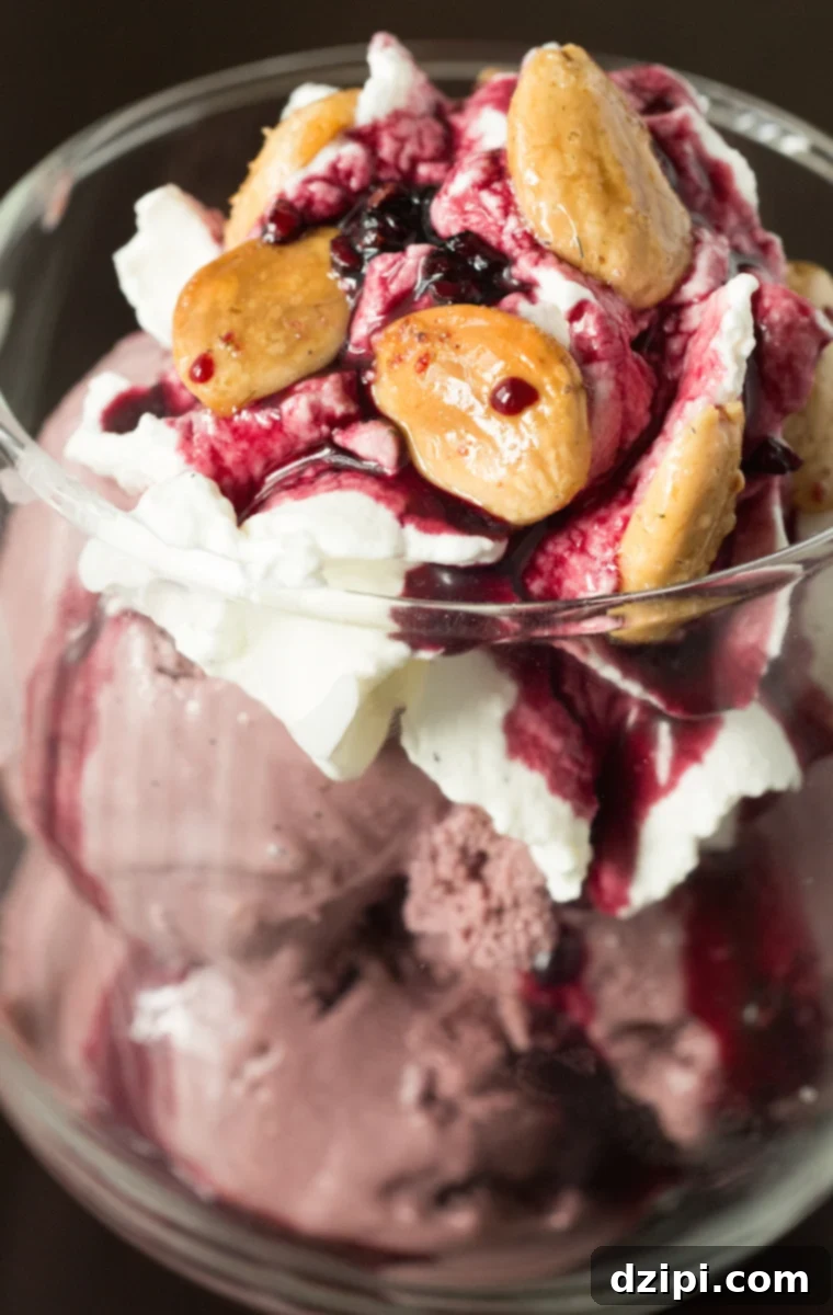 A luxurious Red Wine Ice Cream Sundae with a generous topping of vanilla bean whipped cream, a sweet drizzle of spiced red wine syrup, and a sprinkle of aromatic lavender almonds.
