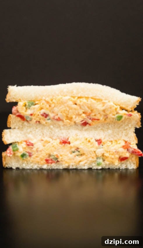 A delicious pimento cheese sandwich made with soft white bread, on a rustic background.