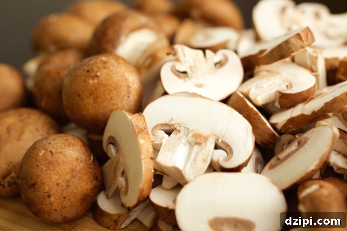 A close-up shot of thinly sliced fresh mushrooms, ready for cooking.