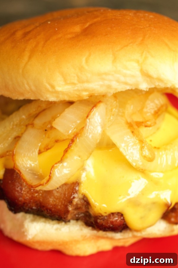 A vertical close up of a Cheese Stuffed Bacon Wrapped Burger