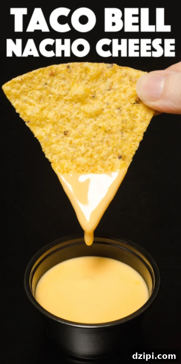 Close up of a tortilla chip that's been dipped in nacho cheese. Text at the top reads 