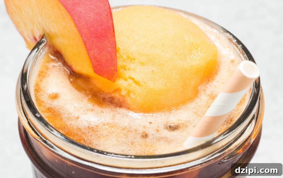 Peachy Tea Cloud Float 2 Close-up of a refreshing Peach Tea Float, garnished with a fresh peach slice, perfect for cooling down on a hot day.