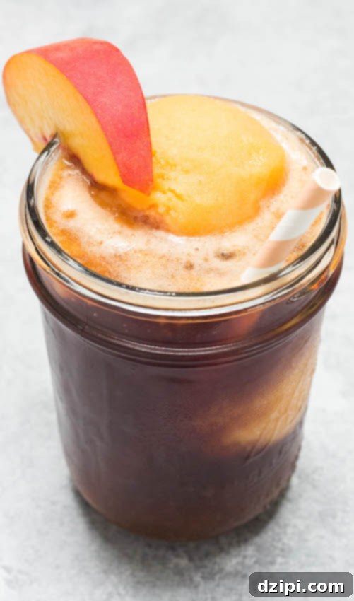 Peachy Tea Cloud Float 4 A perfectly crafted Sweet Tea Float with Peach Sorbet, elegantly served in a mason jar with a whimsical paper straw and a fresh peach slice garnish, symbolizing pure summer bliss.