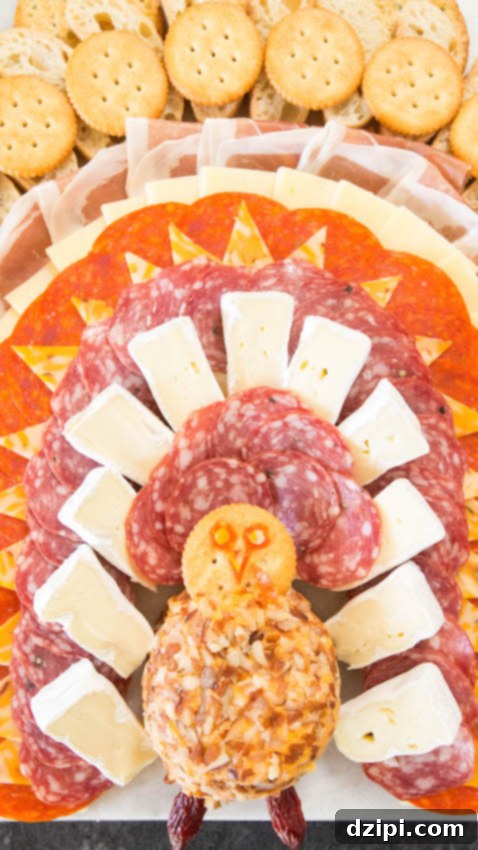 Detailed shot of the 'feather' arrangement on a turkey-shaped charcuterie board, showcasing different meats and cheeses.