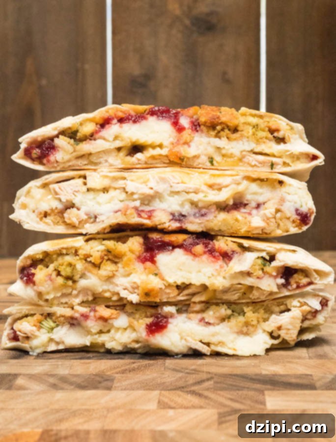 Next-Level Thanksgiving Leftover Crunchwrap 4 Two perfectly golden-brown Thanksgiving Leftovers Crunchwraps stacked artfully on a plate, ready to be served and enjoyed.