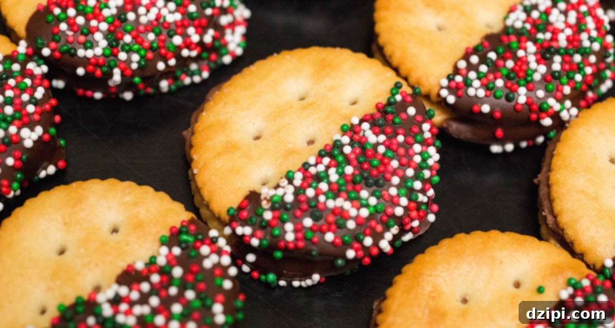Delicious chocolate-dipped Rolo stuffed Ritz crackers adorned with festive Christmas sprinkles, arranged on a sleek black background.