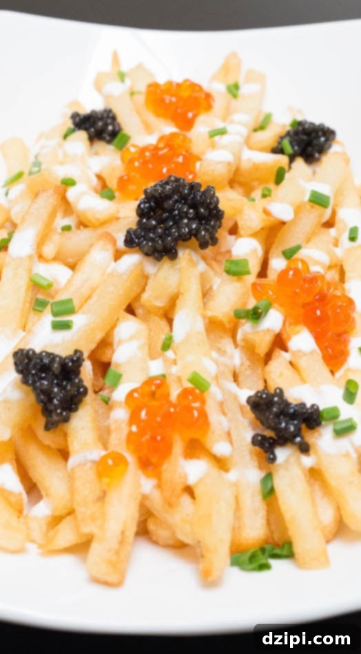 Close-up view of golden Caviar French Fries, generously topped with glistening black and orange caviar.