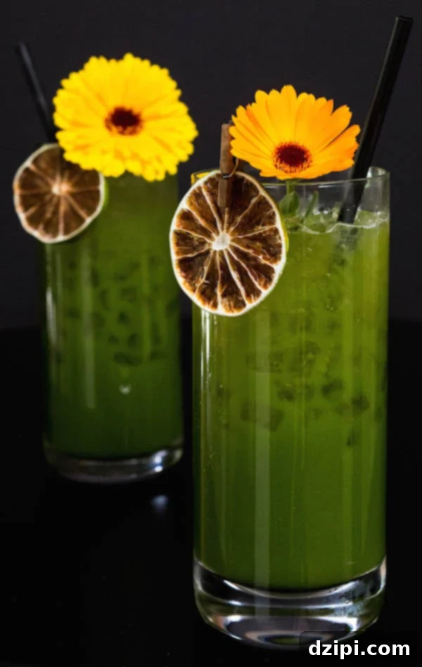 Two highball glasses of Green Juice Margaritas, showcasing their vibrant color and freshness.