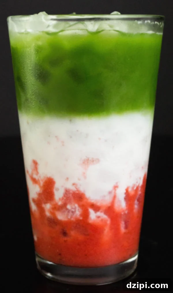 Visually stunning Strawberry Matcha Latte with distinct pink, white, and green layers in a tall glass.
