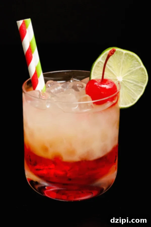 Zesty Cherry Limeade Refresher 3 A single Cherry Limeade Cocktail against a dark, elegant background.